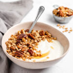 A Bowl Of Yogurt With Granola On Top