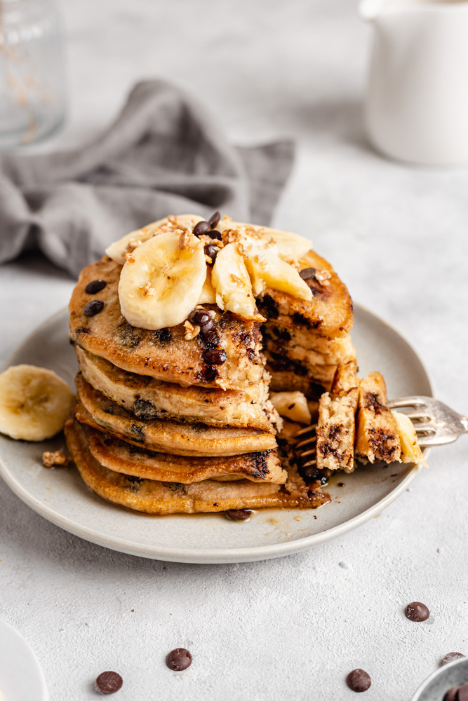 Chocolate Chip Pancakes Served With Banana And Maple syrup