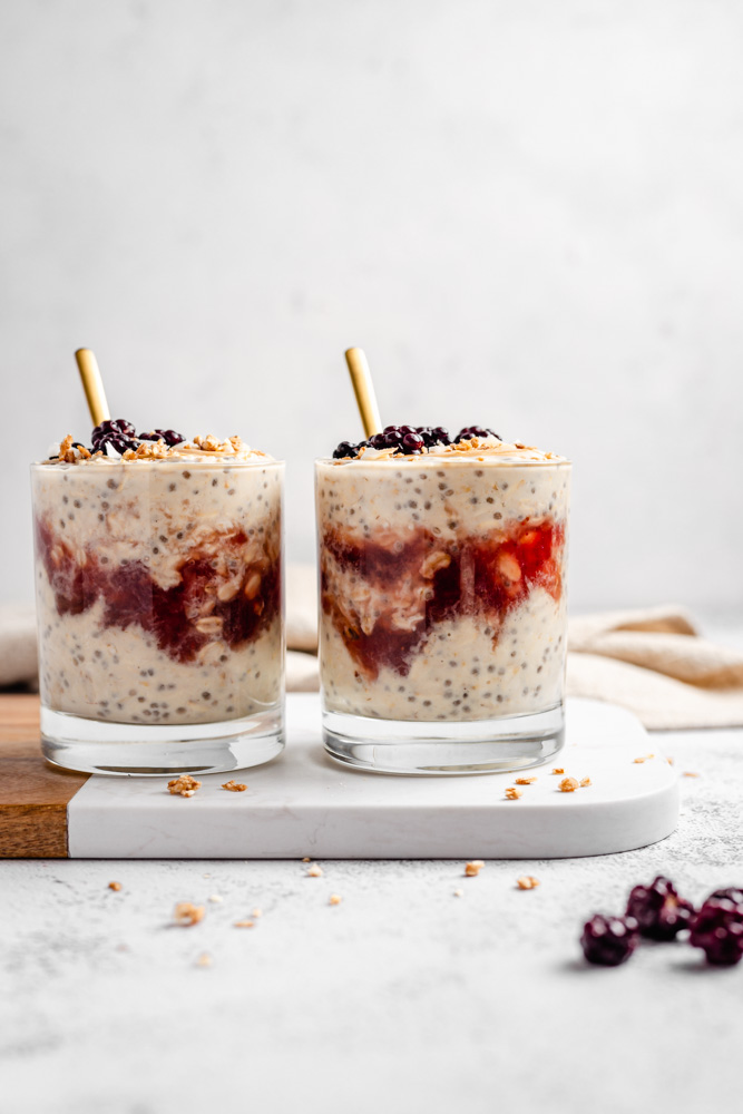 Two Glasses With Peanut Butter Overnight Oats With Strawberry Jam Swirl