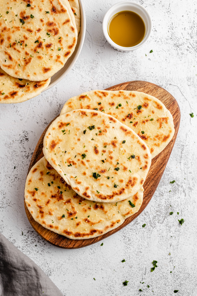 Naan Bread Served With Garlic Butter And Chopped Parsley